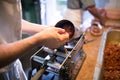 Unrecognizable man putting meat ball into sausage filler, close Royalty Free Stock Photo