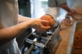 Unrecognizable man putting meat ball into sausage filler, close Royalty Free Stock Photo