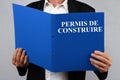 Man Reading the French Building Permit File