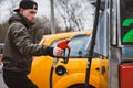 Unrecognizable man refueling car from gas station filling benzine gasoline fuel in car at gas station. Petrol high