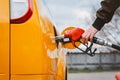 Unrecognizable man refueling car from gas station filling benzine gasoline fuel in car at gas station. Petrol high