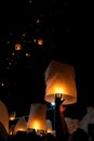 Unrecognizable man releasing paper lantern during Loi Krathong and Yi Peng festival in Chian Mai Royalty Free Stock Photo