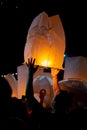 Unrecognizable man releasing paper lantern during Loi Krathong and Yi Peng festival in Chian Mai Royalty Free Stock Photo