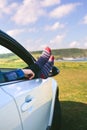 Unrecognizable man resting feet up sitting on the car Royalty Free Stock Photo