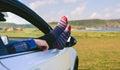 Unrecognizable man resting feet up sitting on the car Royalty Free Stock Photo