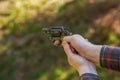 Unrecognizable man with revolver aiming target on shooting range training outdoors.