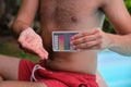 Unrecognizable man using a ph and cl kit to test the pool water quality.