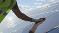 Crop technician removing dust from photovoltaic panel