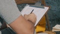 Crop archaeologist making notes on clipboard