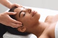 Unrecognizable masseuse massaging relaxed black lady head Royalty Free Stock Photo