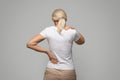 Unrecognizable mature blonde woman suffering neck and back pain Royalty Free Stock Photo