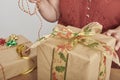 Unrecognizable mature woman wrapping Christmas gifts at home Royalty Free Stock Photo