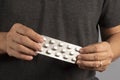 Unrecognizable men hands hold blister with pills, from different diseases Royalty Free Stock Photo