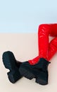 Unrecognizable model wearing red leather pants and trendy platform boots. Fashion 90s style, Clubbing, street outfit. Minimalist