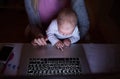 Unrecognizable mother with son on lap, working on laptop Royalty Free Stock Photo