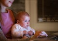 Unrecognizable mother with son on lap, working on laptop Royalty Free Stock Photo