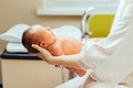 Unrecognizable mother& x27;s holding her newborn baby child after labor in a hospital at next day. Mother sits on bed holds Royalty Free Stock Photo