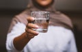 Unrecognizable Muslim Woman Offering Glass Of Water To Camera Indoors Royalty Free Stock Photo