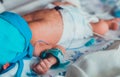 Unrecognizable newborn baby in infant warmer