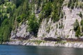 Unrecognizable people climbing on Laserer alpin via ferrata over Vorderer Gosausee lake near Gosau, Austria Royalty Free Stock Photo