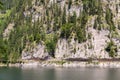 Unrecognizable people climbing on Laserer alpin via ferrata over Vorderer Gosausee lake near Gosau, Austria Royalty Free Stock Photo