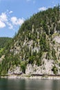 Unrecognizable people climbing on Laserer alpin via ferrata over Vorderer Gosausee lake near Gosau, Austria Royalty Free Stock Photo