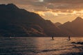 Unrecognizable people floating on river in evening