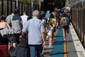 Unrecognizable people, passengers on suburb train station platform