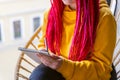 Unrecognizable person, girl artist, illustrator draws in notebook, makes sketch. A woman with long pink dreadlocks in informal Royalty Free Stock Photo