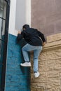 Unrecognizable person hanging on the walls outdoors.