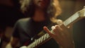 Unrecognizable person playing guitar in studio. Man hand pinching chords indoor. Royalty Free Stock Photo