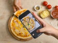 Unrecognizable person using smartphone taking photo top view shot of delicious tasty juicy corn and ham cheesy pizza placed on Royalty Free Stock Photo