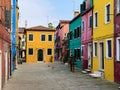 Colorful houses on a small traditional square at Burano island, Venice