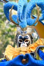 unrecognizable person wearing a Venetian Harlequin mask during a carnival