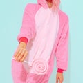 Unrecognizable Pink Pajamas Party Girl.  Lollipop lover. Minimal. Home Relax style. Kigurumi shop Royalty Free Stock Photo