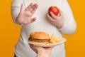 Unrecognizable plus size girl refusing to eat fast junk food Royalty Free Stock Photo