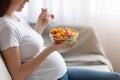 Unrecognizable Pregnant Lady Eating Fresh Vegetarian Salad From Bowl, Enjoying Healthy Nutrition Royalty Free Stock Photo