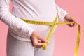 Unrecognizable Pregnant Lady Measuring Belly Standing Over Pink Background, Cropped Royalty Free Stock Photo