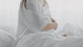 Unrecognizable Pregnant Lady Touching Belly While Sitting In Bed, Suffering Prenatal Contractions Royalty Free Stock Photo