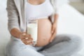 Unrecognizable pregnant woman holding glass of milk, cropped Royalty Free Stock Photo