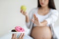 Unrecognizable pregnant woman saying no to unhealthy food Royalty Free Stock Photo