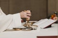 Unrecognizable Priest holding the goblet during a wedding ceremony nuptial mass. Religion concept