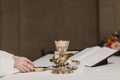Unrecognizable Priest holding the goblet during a wedding ceremony nuptial mass. Religion concept