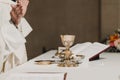 Unrecognizable Priest holding the goblet during a wedding ceremony nuptial mass. Religion concept