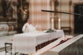 Unrecognizable Priest during a wedding ceremony nuptial mass. Religion concept. Selective focus