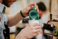 Unrecognizable Professional barista preparing hot milk foam, pourin milk in paper cup with coffee cappuccino Royalty Free Stock Photo