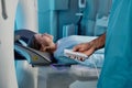 Unrecognizable Doctor Adjusting MRI Scanner For Patient