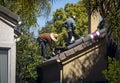 Unrecognizable Roofers working on a residential roof wearing hats Royalty Free Stock Photo