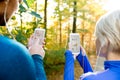 Unrecognizable running couple with smart phones and earphones Royalty Free Stock Photo