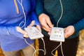 Unrecognizable running couple with smart phones and earphones